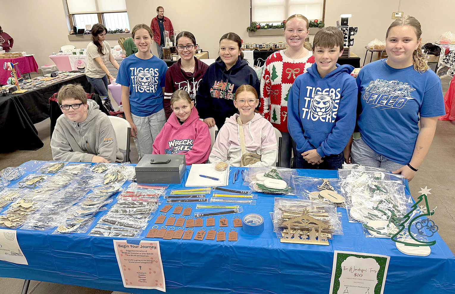 HOLIDAY MALL BOOTH WORKERS at City Hall: Front row, from left, Vernon Waters, Shoni Jones, and Omree Dibble (all seated); standing from left, Kelsey Clayton, Raicelynn Huenergarde, Haddie Carpenter, Lily Yohon, Eli Atkisson, and Shelby Thayer.