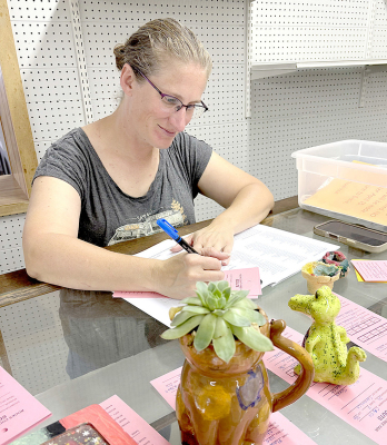 CATHY NAUKAM helped submit several Girl Scout items for the Rooks County Free Fair in the Open Class building.