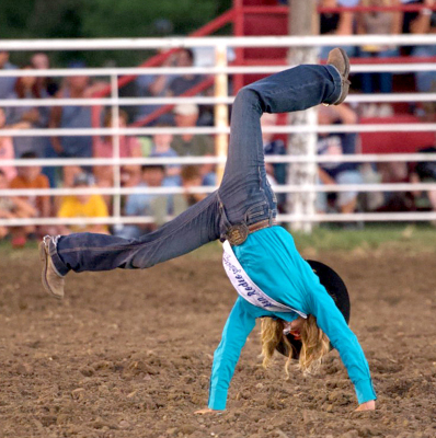 WHAT STARTED OUT with five blindfolded contestants, ended with one blinded Ransom Nussbaum from Plainville, who was still being urged by the rodeo clown, Houston Stuart, to keep being creative. Nussbaum, the newly crowned McCracken Rodeo Princess, kept doing her thing, and she won the “new car”— a small toy. She was a good sport even though she “performed alone” for much of the time. (Photo courtesy of Candace Rachel)