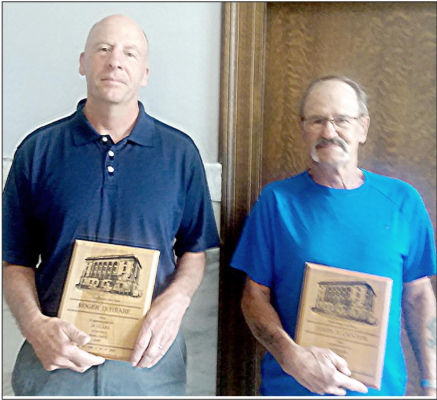 RECEIVING THEIR PLAQUES at a recent Rooks County Commission meeting for their years of service at the County were Roger Hrabe (20 years) and James Cantor (10 years).