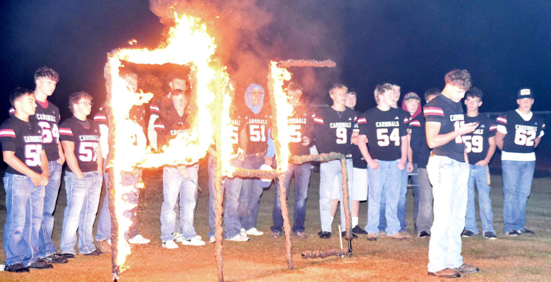 Plainville senior Braylon Becker (front right) gives a talk during the Homecoming bonfire held last Thursday.