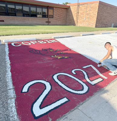 CORBIN KEAS was thinking ahead Sunday evening, August 2, and painting his senior year parking space. A tradition for PHS senior to design their personal parking space to use throughout the year. With a busy week at the Rooks County Fair Corbin wanted to be sure to have his space complete. He used his artistic talents to free hand his Cardinal. He is the son of Jacob and Caroline ( Hrabe) Keas. (Photo Courtesy of Carol VanDyke)