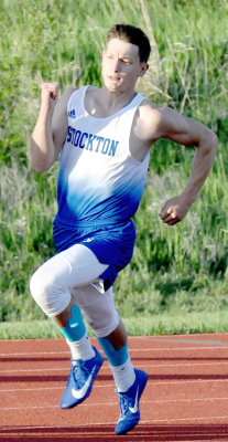 SHS JUNIOR CAMDEN IWANSKI rounds the curve and heads for the finish line in the 200 Meter Dash finals at Regionals in Mankato last Friday. Iwanski qualified for State, finishing third with a PR time of 23.18.