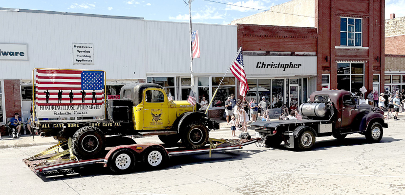 A PATRIOTIC FLOAT honoring veterans who served in the military rolls proudly down the parade route at this year’s Paradise Creek Festival in Plainville, paying tribute to local heroes and their service.
