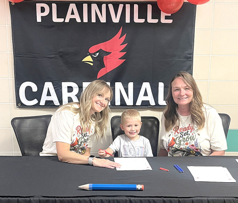 IT WAS ALL SMILES FOR RYKER HAMEL who signed his letter of intent to be a Cardinal during the Kindergarten Signing on Tuesday, August 11th at Plainville Elementary. Pictured are (from left) Jennie Hovis, Ryker Hamel, and Dana Friend. (Courtesy Photo)