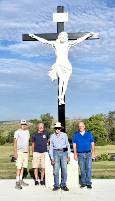 became a reality on Monday, July 21st, when it was installed. Some of the Knights of Columbus were on hand for the memorable occasion. Pictured are (from left) Pete Bellerive, Roger Roy, Francis Mahoney, and David Reed. THE DREAM OF A CRUCIFIX in the St. Thomas Catholic Cemetery