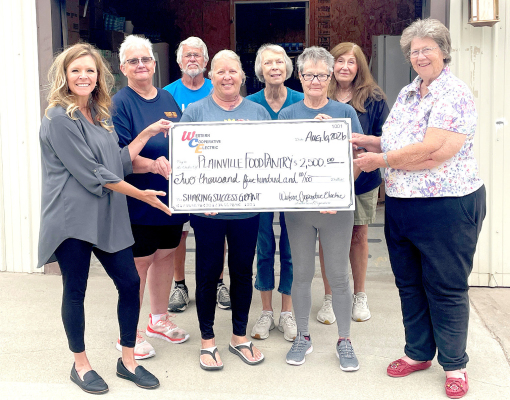 LEFT TO RIGHT: Christina Hayes (WCE Member Services Manager) with food bank volunteers Jeanie Rolfe, Mark Glendenning, Kim Knouf, Nan Hilgers, Lola Meitler, Susan Rank, and Director Janet Swafford.