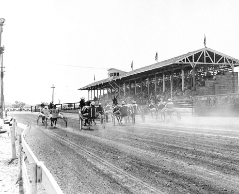 HARNESS HORSE RACING at the Rooks County Fair began in the mid-1890s and remained one of the main attractions of the annual event until the 1990s. Parimutuel betting was introduced in 1989 with a page in the Fair book dedicated to “How to Bet.” Everyone in town knew Fair Week had begun when they would see the starting gate vehicle for the trotters roll into town! “And they're off!'