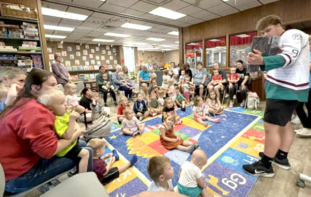 CORBYN MEYERS from PHS reading during Story Time.