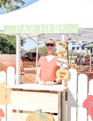 MEGAN WISE OF STOCKTON helped man the pumpkin patch at this year’s festival in the Lower City Park, where festival-goers stopped by to pick out the perfect pumpkin.