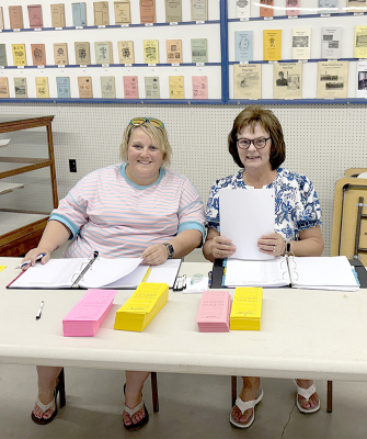 KYLEIGH STICE AND PAT COOK, members of the Rooks County Free Fair Board, assisted with entries in the Open Class building on Saturday, just before the Fair began.