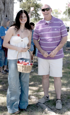 KERRY MCCUE OF HAYS was among those at the Memorial Day Services at Stockton Cemeter who received a poppy from Shyanne Balthazor as a remembrance, sacrifice, and honor for military service members who died in war.
