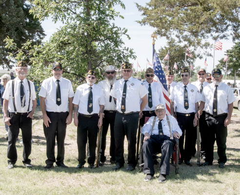 Members of VFW Post 8873 conducted Memorial Day services at Stockton Cemetery on Monday, honoring the men and women who made the ultimate sacrifice in service to their country. From left are: Rick Maynard, Tim Johnston, Quinn Baize, Charlie Sander, Shayn Balthazor, Mark Trumbo, John Berkley (seated), Ed Thayer, David Atwood, Benney Wise, and Mack Palmer.