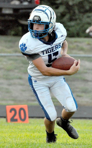 EMERSON LOWRY looks upfield after catching a kickoff from the Trojans during the game against Logan/Palco last Friday.