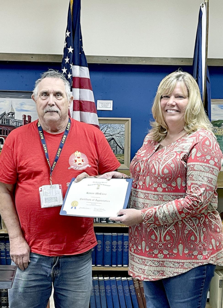 BILL POSSON, Stuggart, recently presented Karen McCune with a Certificate of Appreciation for her presentation to the Fort Hays Chapter of the Sons of the American Revolution regarding the Quilt of Valor Program.