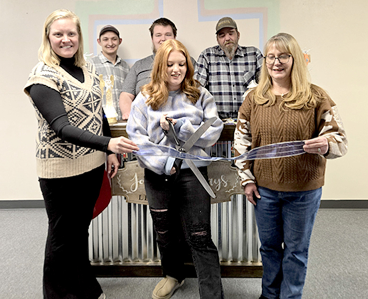 THE LIVING LIGHT BOUTIQUE recently held a Grand Opening and Ribbon Cutting. Pictured are (front row, from left) Chamber president Anna Biggs, owner Rihanna Rowe, Misty Higdon; (back row) Chad Rowe, Wes Higdon, and Brad Higdon.