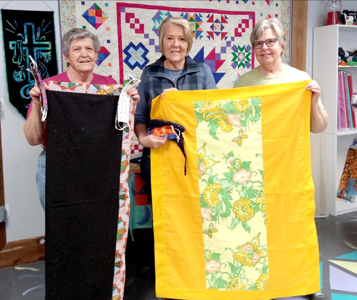 JUDY RUSS, JANIE LOWRY AND IDONA DUNCAN have been busy sewing masks and lap robes to send to family members, hospitals, and other community members during the COVID-19 pandemic.