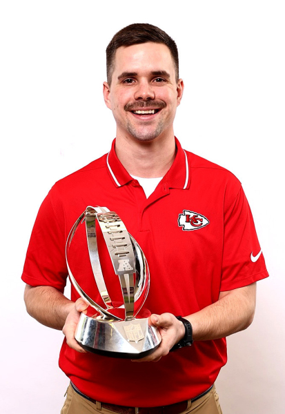 ANDREW BELLERIVE, who works for the Kansas City Chiefs as a Business Development Representative, is pictured holding the AFC Championship Trophy.