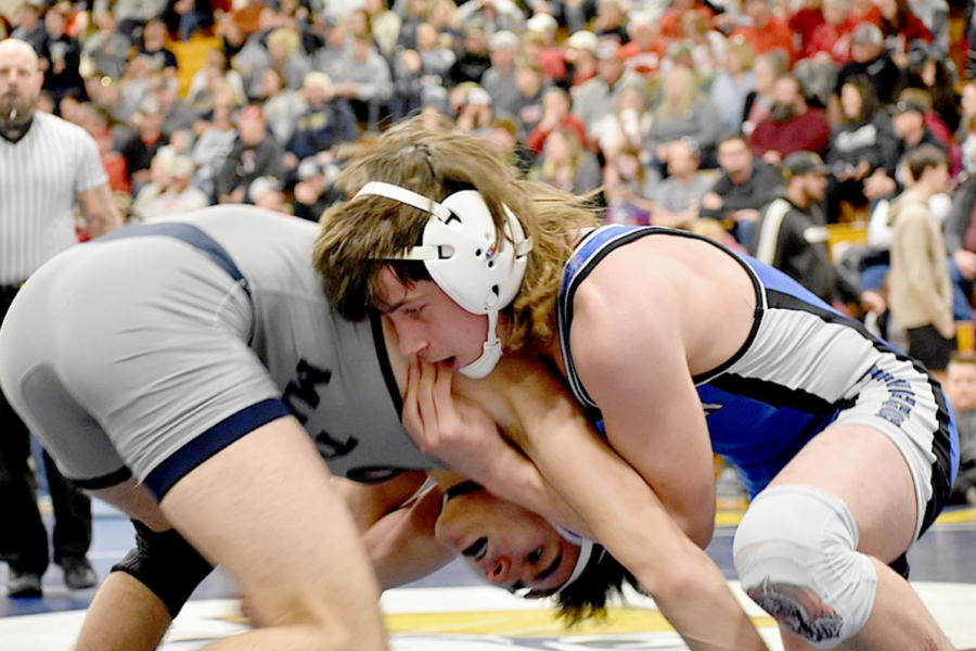 EMERSON LOWRY, a Tiger freshman, earned a trip to the state wrestling tournament after placing fourth at Regionals in Norton. Wrestling at 126, Lowry (right) won by a fall, twice, over TMP’s Braydon Binder (left) en route to the state tourney berth. (Photo courtesy of Bobbi Basart)
