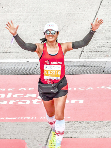 FIELZAH CREIGHTON crosses the finish line at the 45th Bank of America Chicago Marathon, held on Sunday, October 8th. Not only did her daughter, Jayana, cheer her on, but over 1.7 million spectators lined the streets to watch the event.