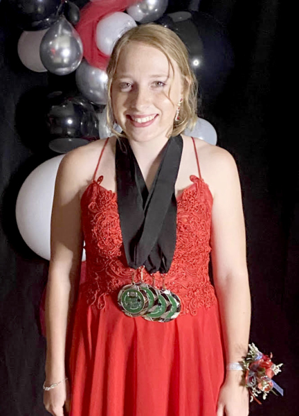 AFTER WINNING THREE MEDALS at the K.E.M.F.A. State Powerlifting Championships on April 23, 2022, Delany Snyder, a senior at the time, returned to Stockton to attend Stockton High School’s Prom that night…sporting her three medals. Snyder placed third overall at State, lifting a total of 430 pounds. (Courtesy Photo)