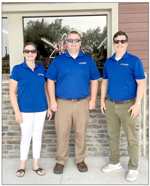 SOLUTIONS NORTH BANK employees Virginia Bice, Chase Look and Brian Berkley help out at the pumps on Friday, June 17th.