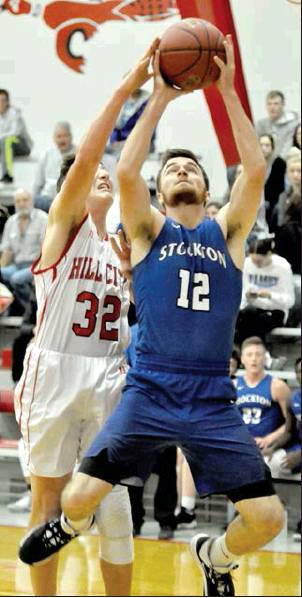 WITH INSIDE POSITION, Tiger Senior Gage Conyac grabs a rebound during the Tigers’ opening game against Hill City, as the Ringneck player, Derek Keith, attempts to knock the ball loose.