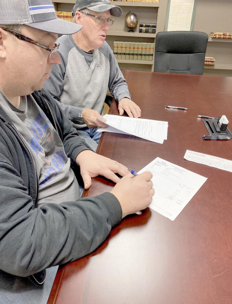 A Done Deal! PRESENT FORTHE SIGNING of the closing papers on the American Legion Building were Stockon Rodders President Dean Kester and treasurer Roger Roy, as well as secretary Libby Kester. Pictured are Dean Kester and Roger Roy signing the papers.