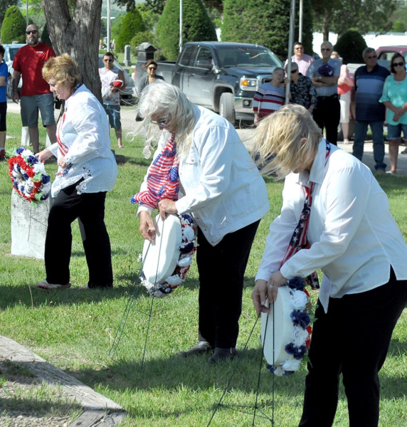 THE VFW AUXILIARY POST 8873 placed flowers at the Stockton City Cemetery during the Memorial Day Services. They are (from left) Jari Atwood, Kathy Creighton and Lisa Gilmore.