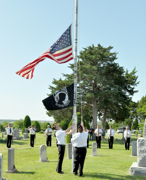 DAVID “CHARLIE” ATWOOD AND DAVID CALVIN, members of the VFW Post 8873, raised and then lowered the flag to half staff during Memorial Day Services at the Stockton Cemetery.