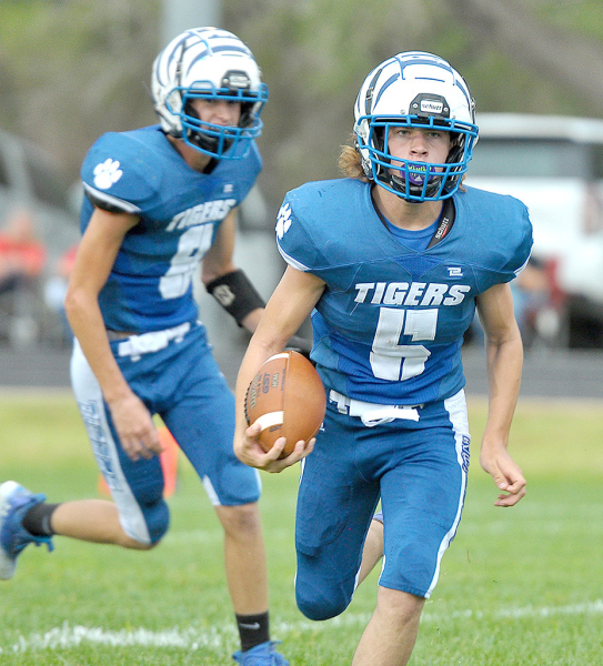 EMERSON LOWRY finds some running room during the Tigers’ game with Logan/Palco last Friday. In the background is quarterback Max Moffet.