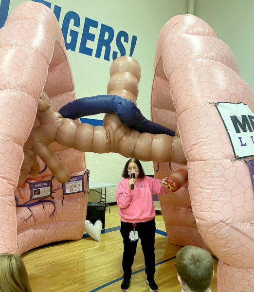 RCH DIRECTORY OF NURSING, PAM HARMON, gives a tour of the MEGA Lungs display to the Stockton Grade School boys and girls. The students learned about general lung health and the dangers of smoking and vaping.