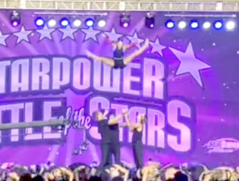 CLAIRE PLUMER (top) gets lots of air with an impressive Toe Touch Basket Toss at the end of the Starpower Dance Force number in Branson, Mo. She, along with Ella Snyder, was chosen to participate in this select group of 46 of the top dancers.