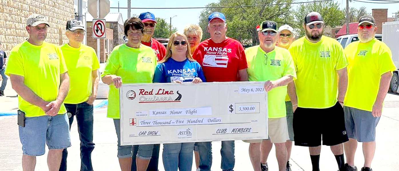 THE PLAINVILLE RED LINE CRUISERS CAR CLUB welcomed home their hometown heroes Dave Anderson, Darrell Kriley, Gary Peters and Galen “Frenchie “ Plante who had returned from a week’s trip with the Kansas Honor Flight. Red Line Cruisers then honored them at Saturday’s Car Show, and gave a $3,500 donation to Kansas Honor Flight! Medic Jenny Niblock, who was also on the trip, was at the Car Show to accept the check. Pictured above are front row, from left: Preston Gosselin, Linda Hagan, Medic Jenny Niblock, Dave
