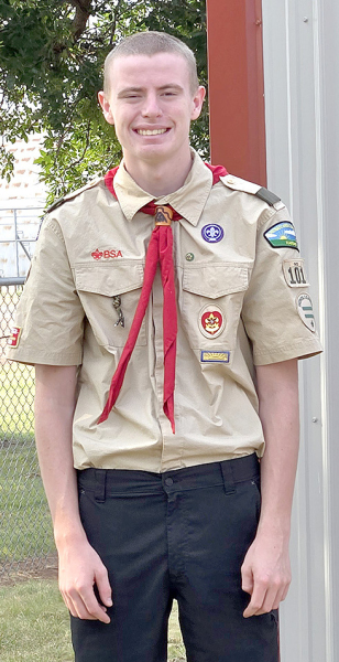 RILEY poses in his scouting uniform, representing years of dedication and achievement.