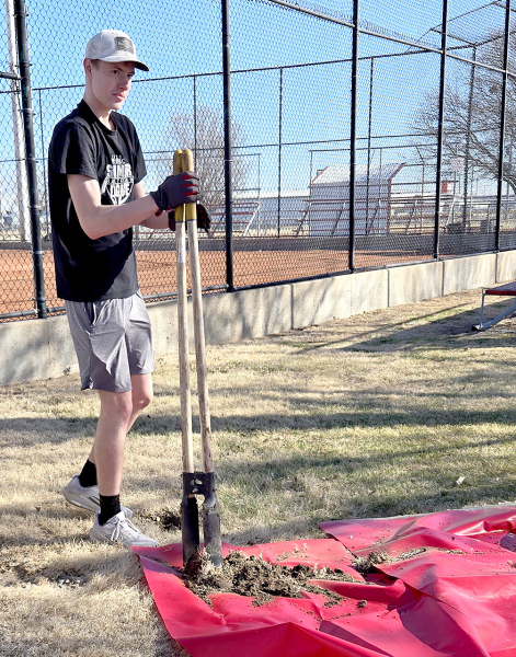 RILEY WORKS on his Eagle Project, digging a hole for one of the new flagpoles at the Plainville ballfields.