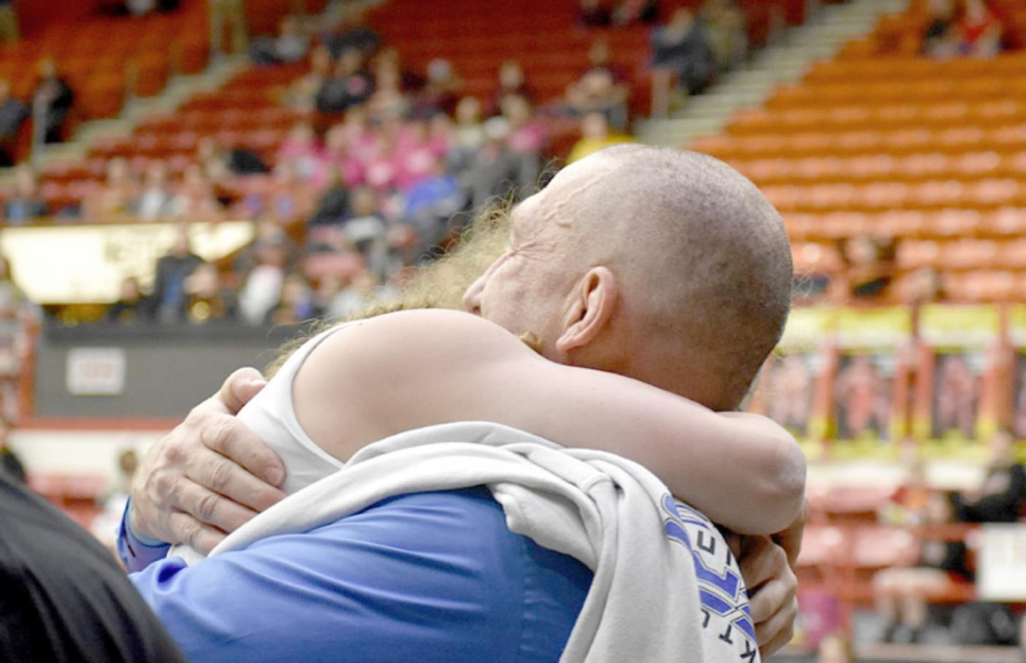 HOW SWEET IT IS! Stockton freshman Ashlyn Hahn is congratulated by Coach Clint Bedore after winning her third-place match against Breanna Ross of Erie by a fall. Hahn wrestled in the 115-lb. division at the 4A-1A State Championship in Salina. (Photo courtesy of Bobbi Basart)