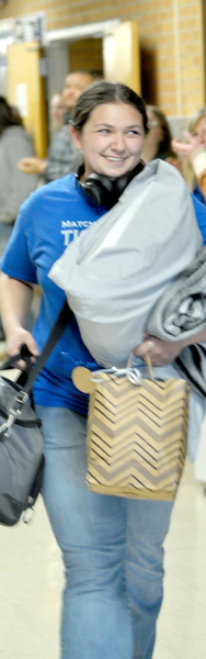 RAVEN LONG, a Tiger senior, leaves the halls of SHS to a cheering crowd at the sendoff last Tuesday to the 4A-1A Girls State Wrestling Championship in Salina. She represented Stockton along with Ashlyn Hahn.