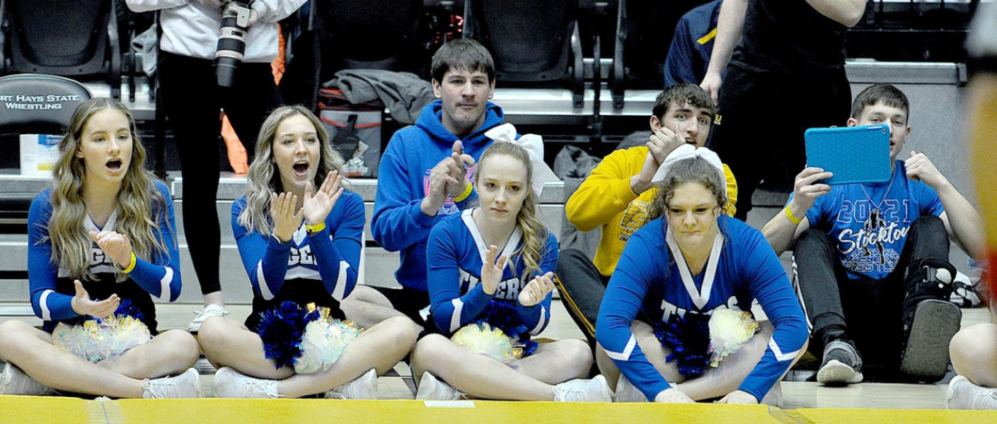 SHS CHEERLEADERS, as well as fellow wrestlers Rylan Basart, Justin Knoll and Camden Iwanski, cheer Emerson Lowry on to a win during state wrestling tournament action. Cheerleaders from left are: Ava Dix, Claire Plumer, Delany Snyder and Addie Struckhoff.