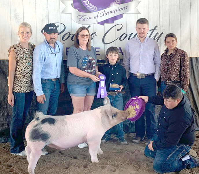 ELI ATKISSON won Grand Champion Market Hog at the 2023 Rooks County Free Fair. Pictured are (from left): Amanda Atkisson, Dan Atkisson, Sharon Muir Russ, Eli Atkisson, Judge Brody Nemecek, Bodye Stithem, and Ryan Mongeau.