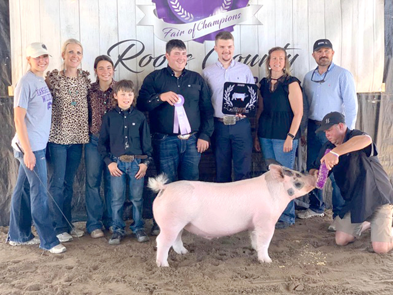 RESERVE GRAND CHAMPION MARKET HOG at the 2023 Rooks County Free Fair went to Ryan Mongeau. Pictured are (from left): Taylor Baetz, Amanda Atkisson, Bodye Stithem, Eli Atkisson, Ryan Mongeau, Judge Brody Nemecek, Dawn Mngeau, Dan Atkisson, and Shane Hammond.