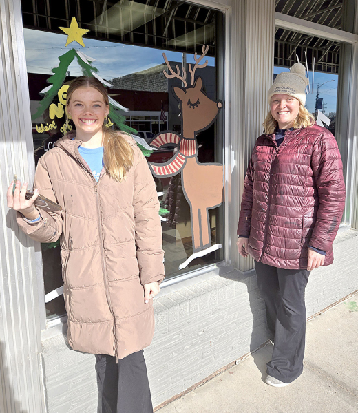 CHAMBER DIRECTOR PAYTON KELLER (left) and Chamber Board Member Anna Biggs (right), were seen painting the business windows along Stockton’s Main Street on Friday last week in anticipation for the Olde Tyme Christmas this coming weekend.