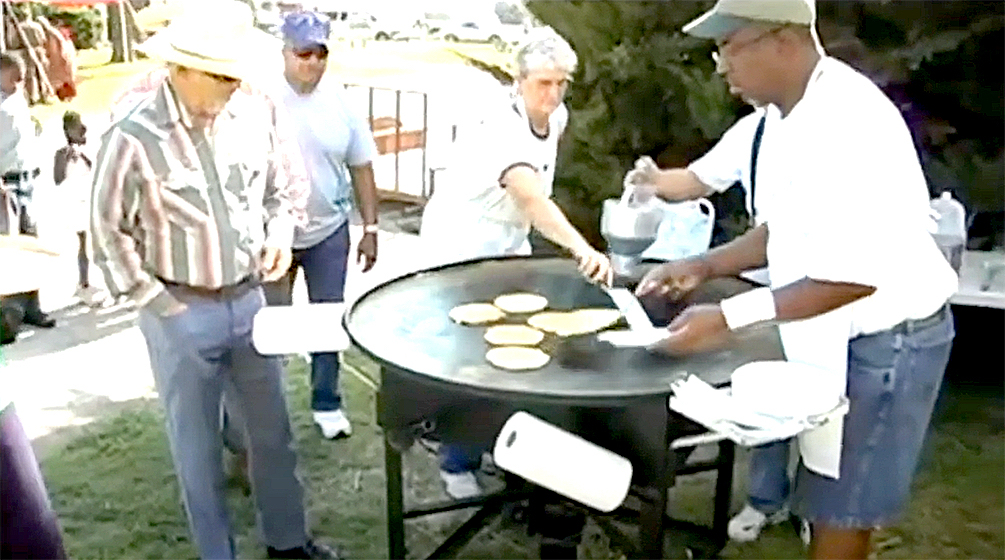 Gil Alexander (right) serves pancakes at the annual Pancake Feed.