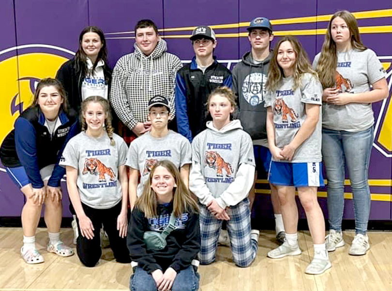THE SHS TIGER WRESTLERS opened their 2022-23 season last Saturday, competing in the Christmas City Wrestling Classic in WaKeeney. Standing from left are: Shyanne Balthazor, Ryan Mongeau, Cameron Balthazor, Emerson Lowry, Jadyn Palmer and Nevaeh Ray (manager); kneeling, from left: Rivver Long, Temprance Northup, Carolina Northup and Ashlyn Hahn; and front row, Mia Odle (manager). (Courtesy Photo)