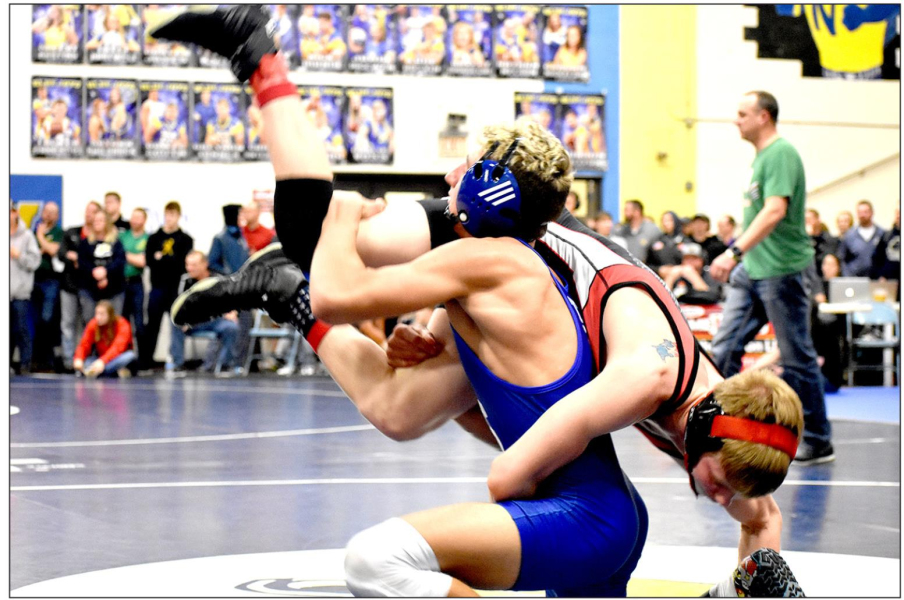 TIGER WRESTLER, Justin Knoll, wrestling at 126 lbs., makes a move against his opponent, Drew Bell of Hoxie. Knoll ended Regionals placing 4th and earning a trip to the State Wrestling Tournament in Hays this Friday and Saturday. (Photo Courtesy of Bobbi Basart)