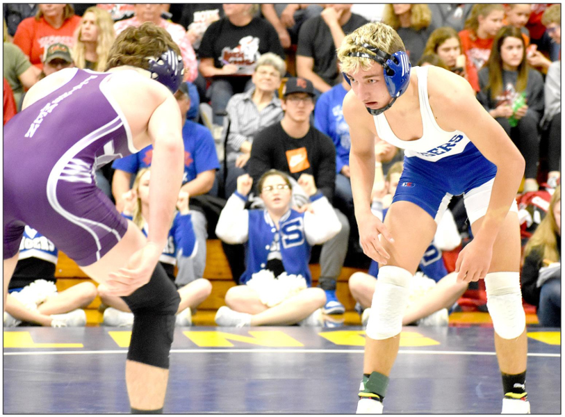 FRESHMAN JUSTIN KNOLL, right, lost a close 5-3 decision to Tyler Schoenberger of Oakley at the Regional Wrestling Tournament held in Norton. However, Knoll ended the tournament fourth and will compete for the first time in the State Wrestling Tournament in Hays this Friday and Saturday. (Photo Courtesy of Bobbi Basart)