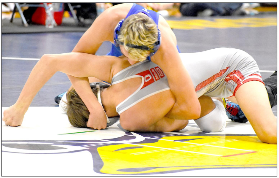 JUSTIN KNOLL (top) makes his move to put himself in position to defeat Breckin Sauvage of Oberlin-Decatur Community by a fall at the Regional Wrestling Tournament in Norton Feb. 21 and 21. (Photo Courtesy of Bobbi Basart)