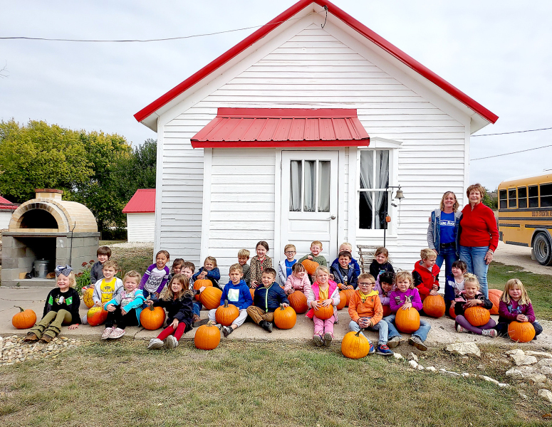 THE STOCKTON THREE- AND FOUR-YEAR-OLD CLASSES of Mrs. Beth Hazen and Mrs. Christine Hamel enjoyed a day at the Prairie View schoolhouse at the O’Grady farm. They learned about what life was like attending a one-room schoolhouse and also enjoying a trip to the pumpkin patch. The two ladies standing to the right are Dawn O’Grady and Joan Balderston.
