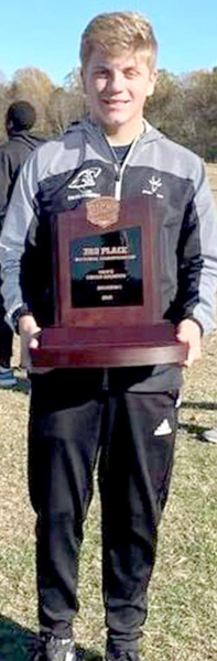 CHAYSE proudly holds the third-place trophy the team won at the 2021 National Cross Country Championship.