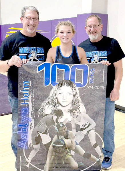 TIGER SENIOR ASHLYN HAHN achieved a milestone at the Christmas City Wrestling Classic in WaKeeney last Saturday, winning her 100th career match. Pictured with Ashlyn are her coaches, Clint Bedore (left), and Justin Basart. (Courtesy Photo)